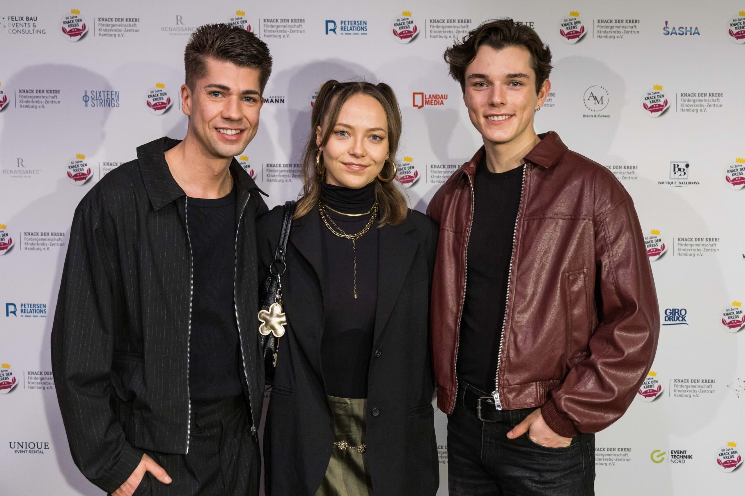 Maximilian Seitz Nele Schomaker Jannik Richter vor Sponsorenwand beim 50 jährigen Jubiläum Knack den Krebs Fördergemeinschaft Kinderkrebs-Zentrum Hamburg Miniatur Wunderland 2026
